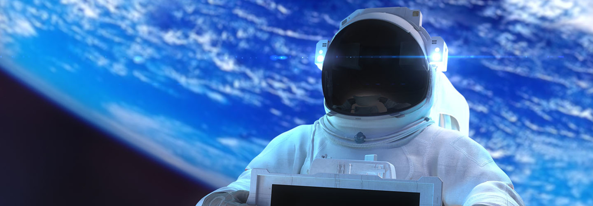 Astronaut holds in hands the electronic display.