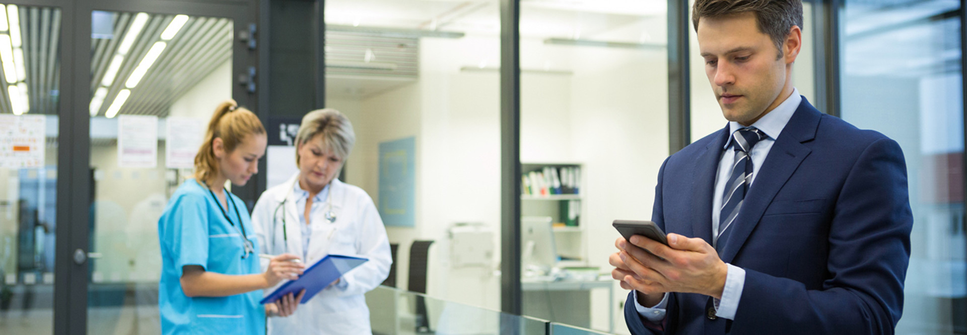 Man using smartphone in a hospital 