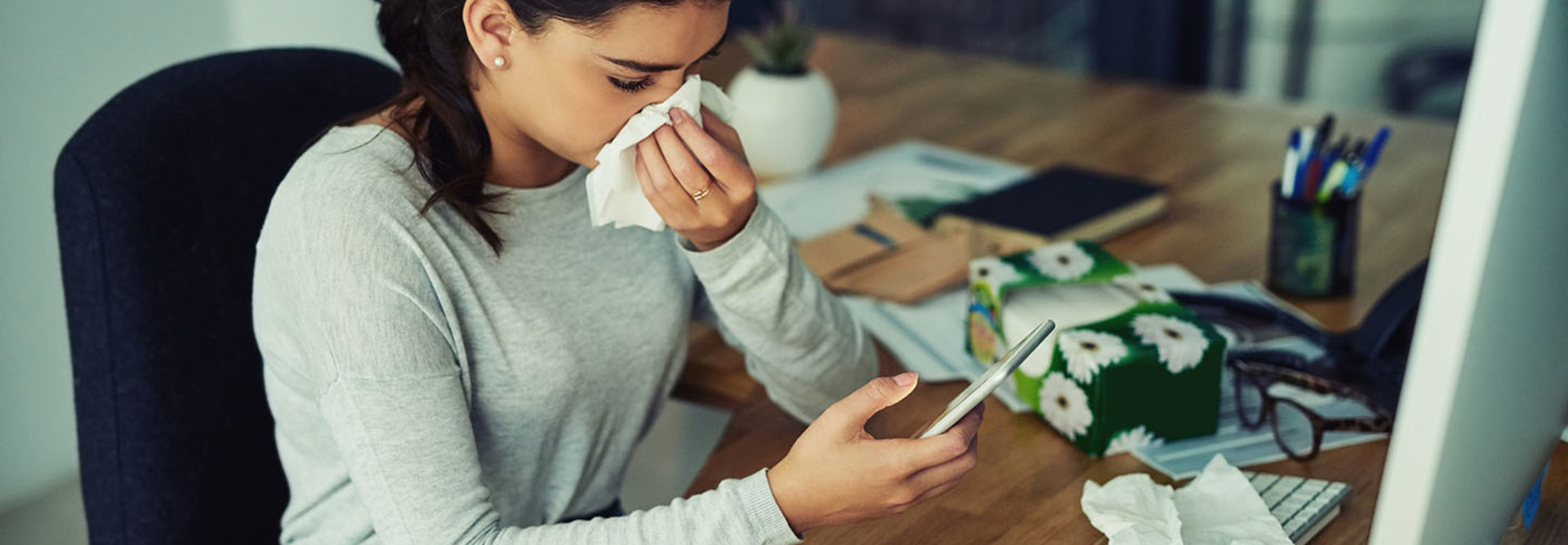 Girl sick with flu on her smartphone