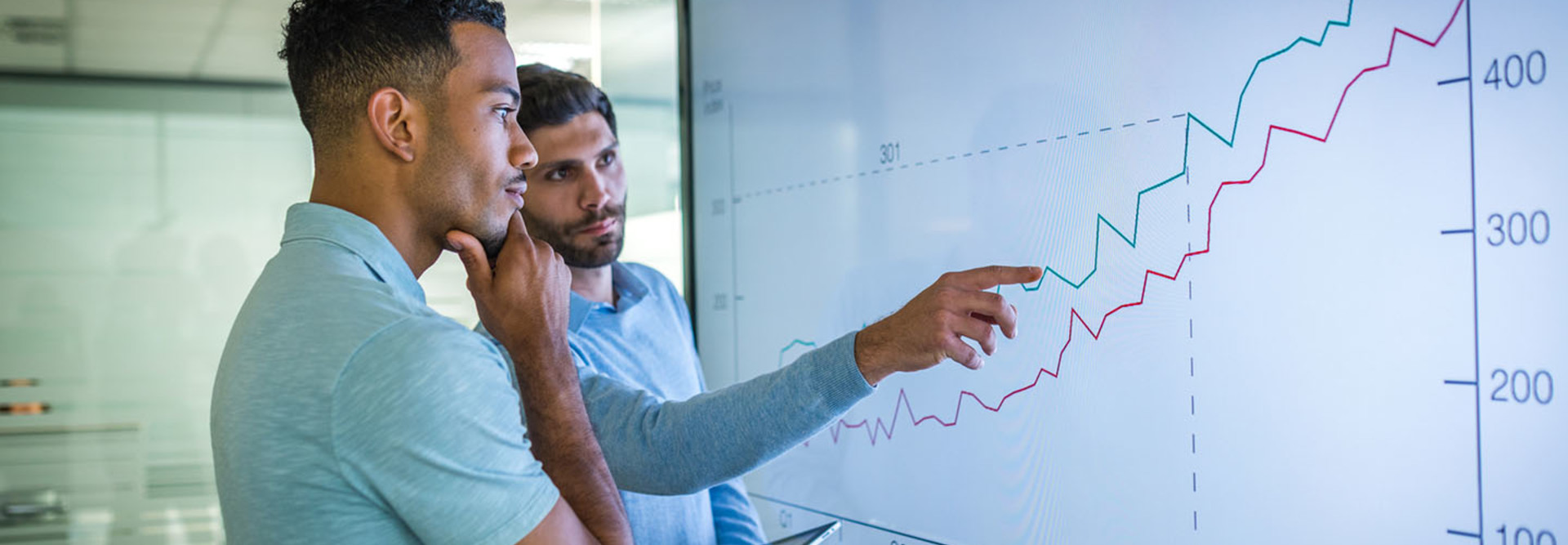 Businessman explaining line graph to his coworker.