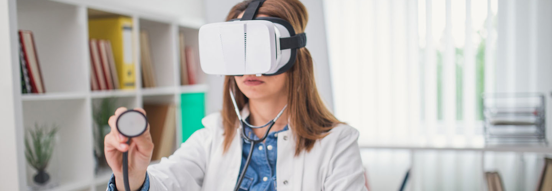 doctor wearing a virtual headset and using a stethoscope.