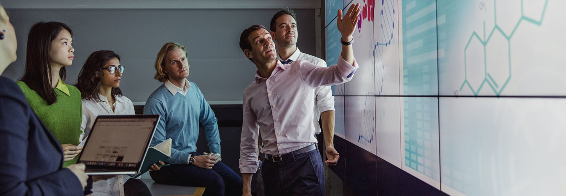 group of workers looking at genomic data presentation