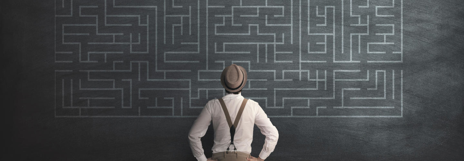 man in fedora looking at chalk maze