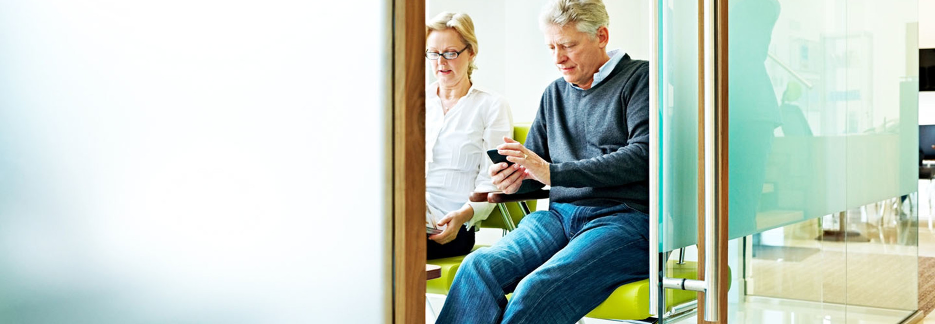 Man in hospital looking at cell phone