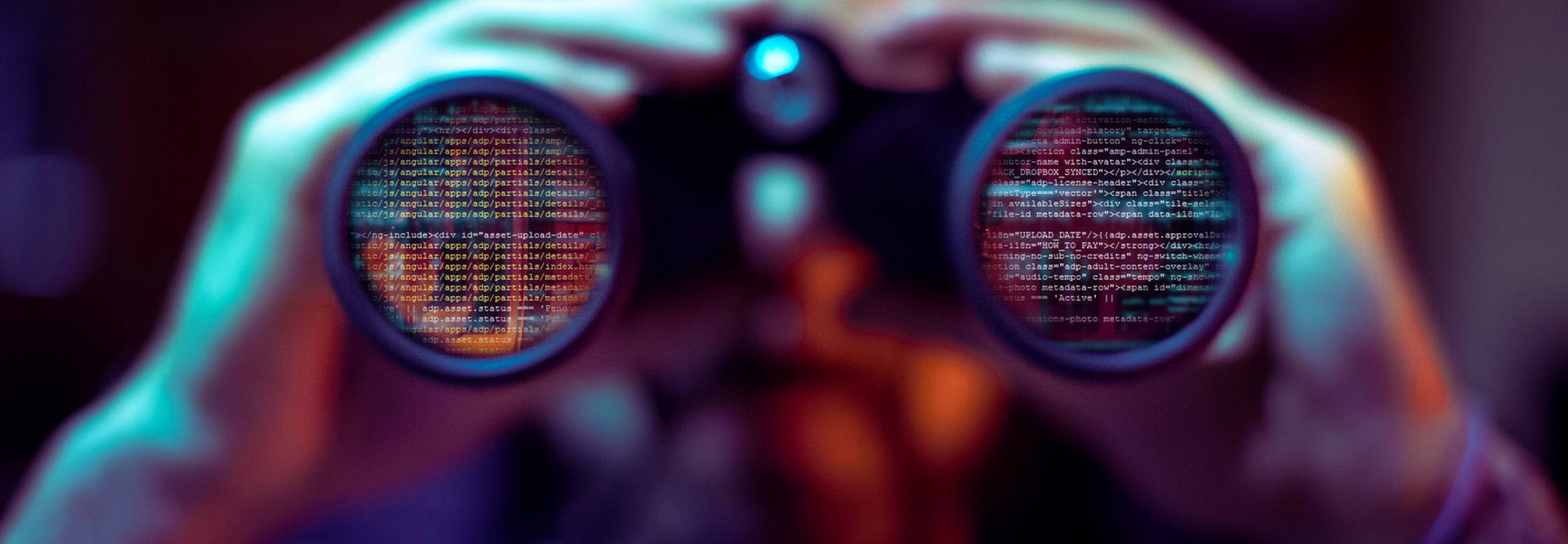 Man holding binoculars looking at data