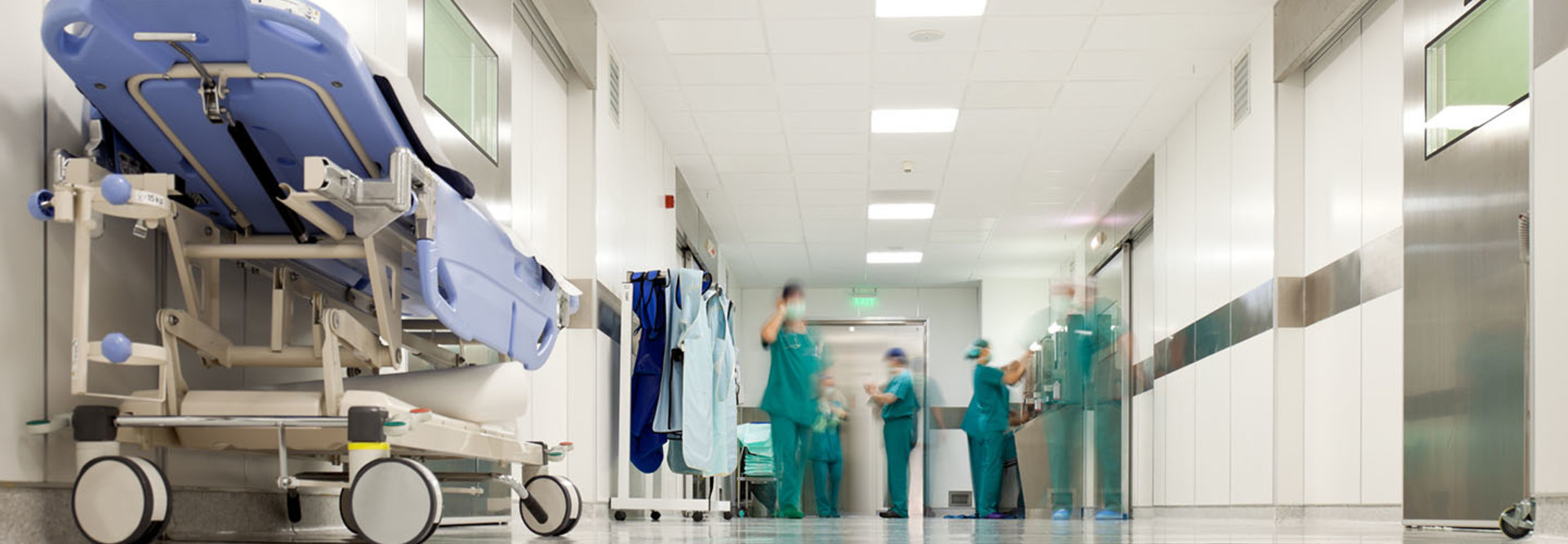 Blurred figures of people with medical uniforms in hospital corridor
