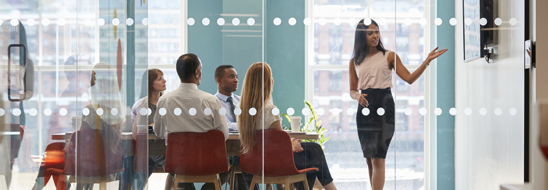 Boss shows presentation on screen at business meeting