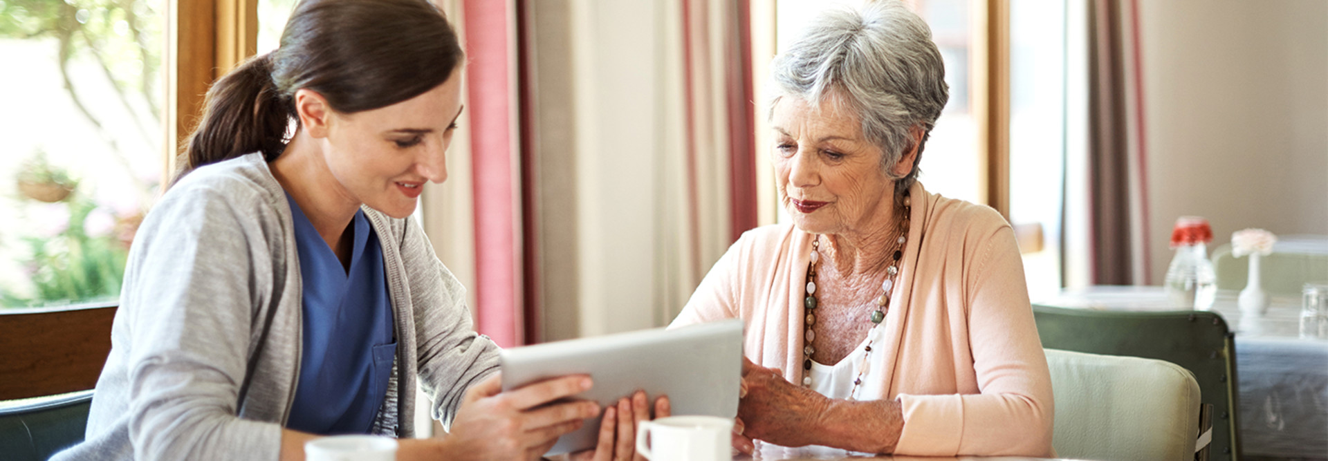 Nurse and senior citizen with ipad
