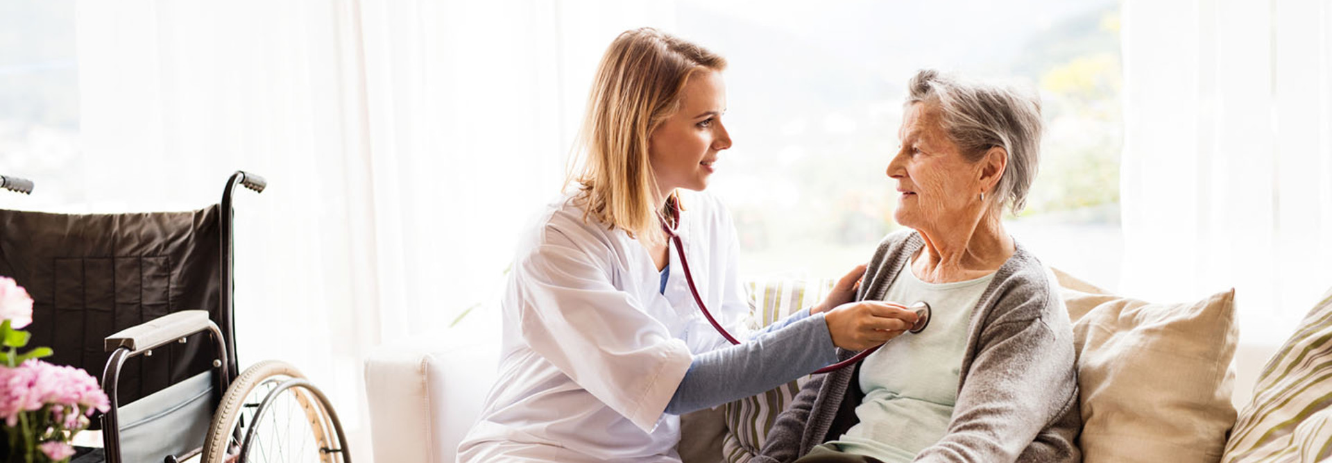 Health visitor and a senior woman during home visit.