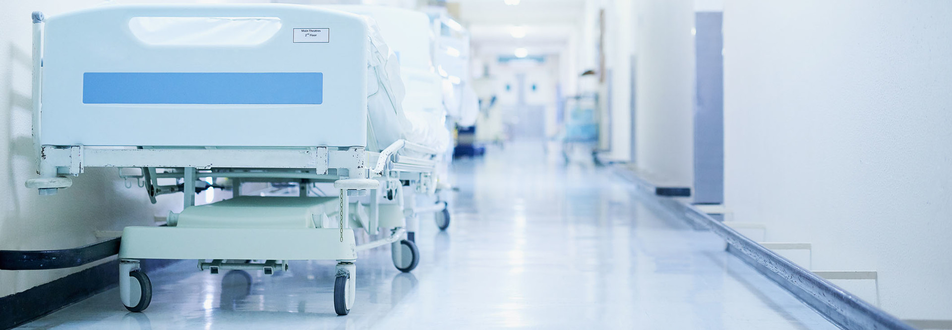 Shot of a hospital bed in an empty corridor of a modern hospital