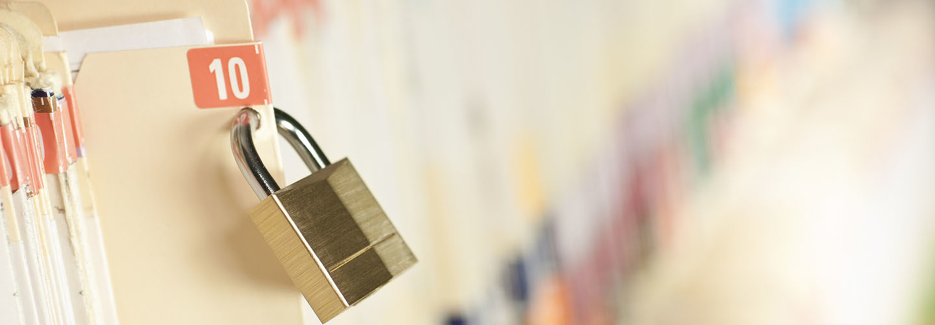 Secure and protected medical records. Bar code added to folder, not actual patient information. Concept image. Narrow depth of field.