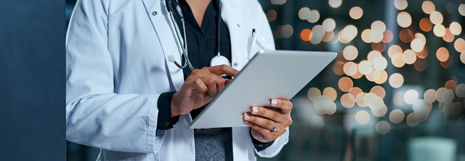 Closeup shot of an unrecognizable doctor using a digital tablet in a hospital at night