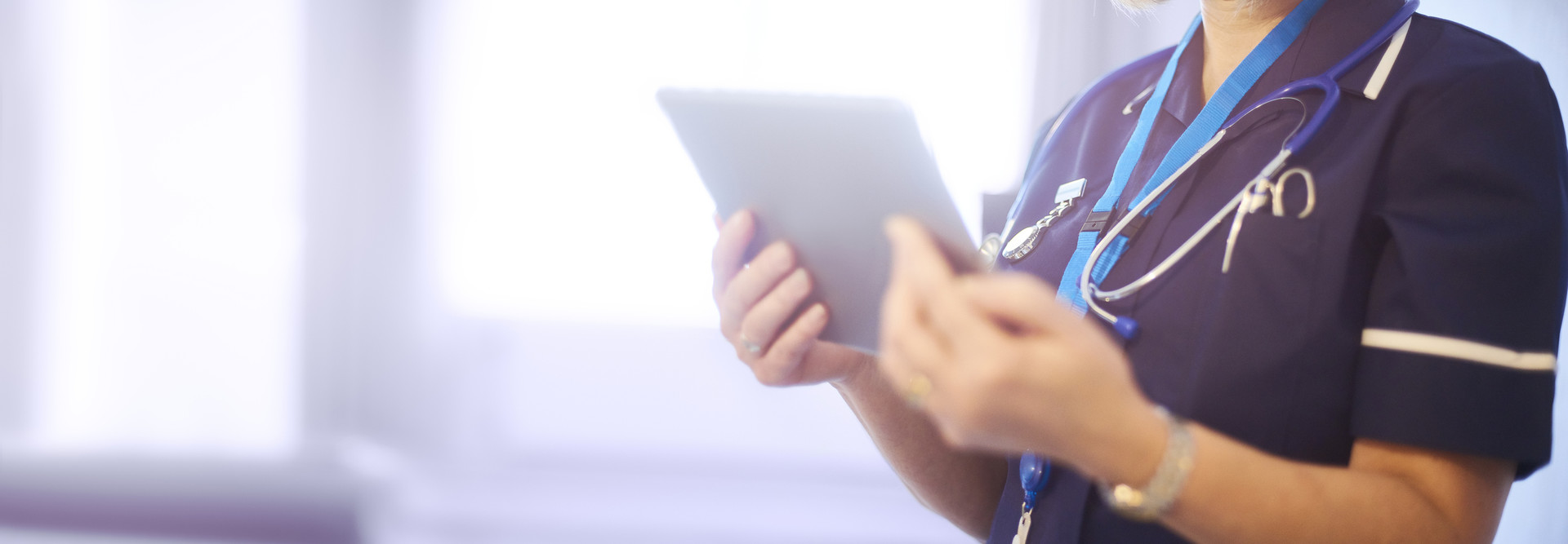 Doctor or surgeon checking patients records on ward