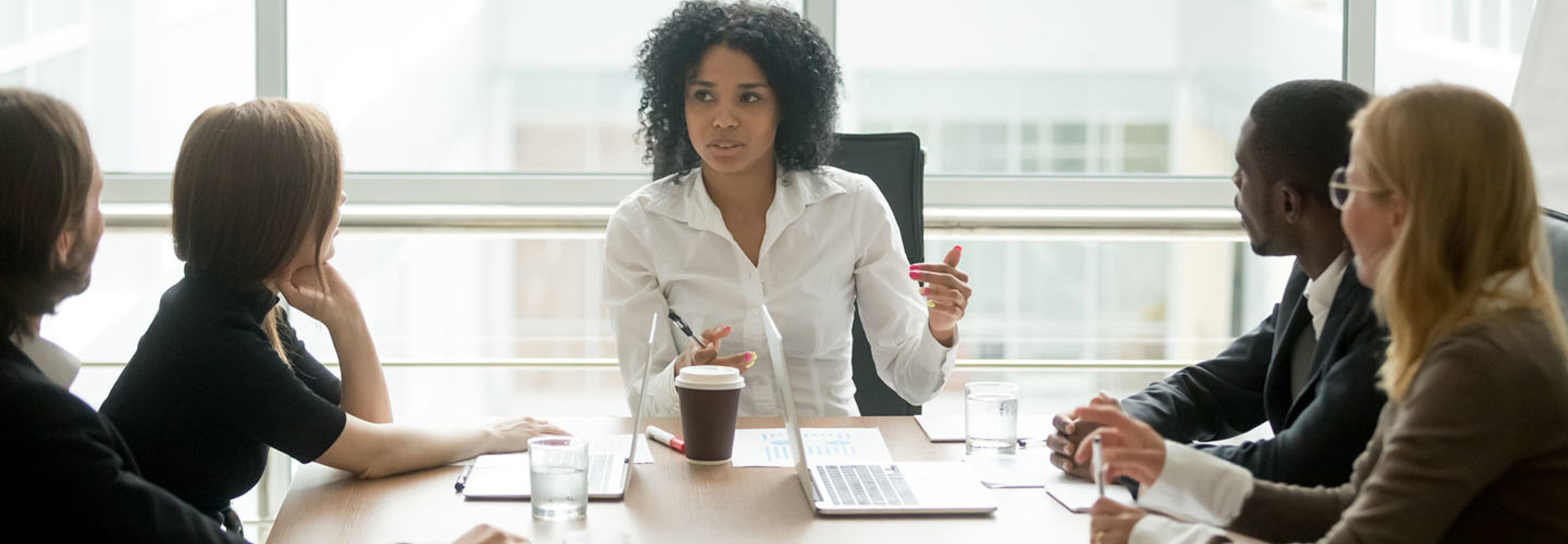 Healthcare CIO speaking with executives at a table