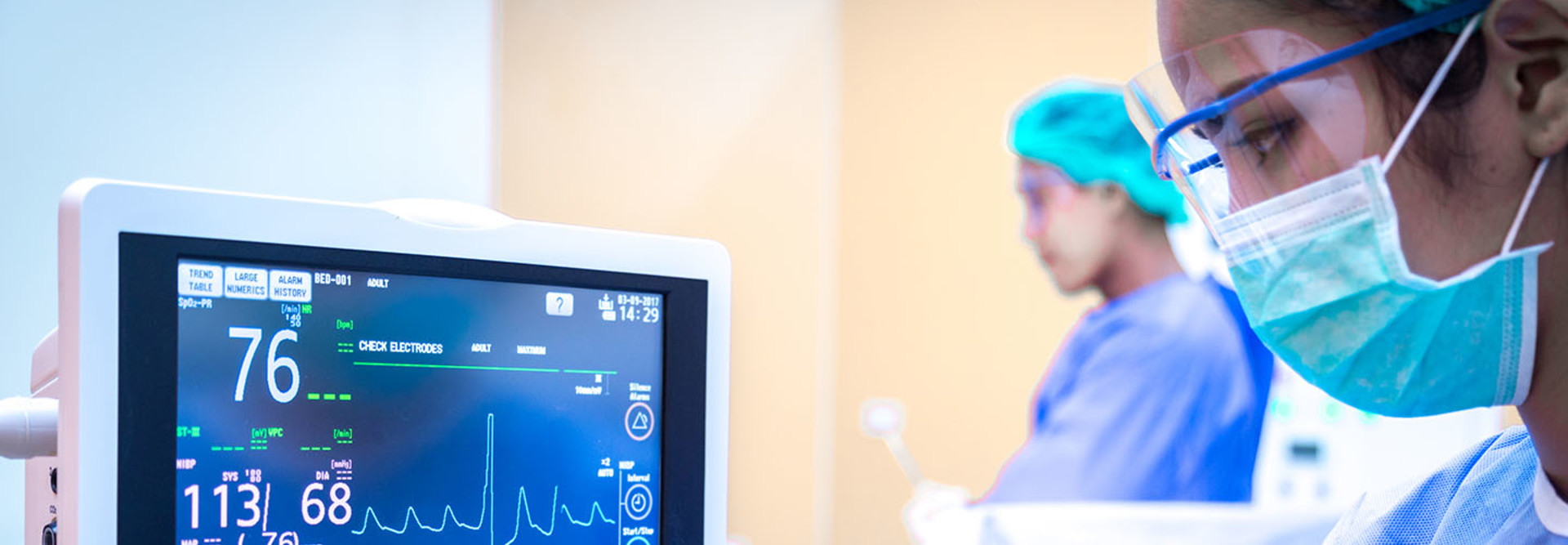 A female surgeon using a monitor in an operating room.