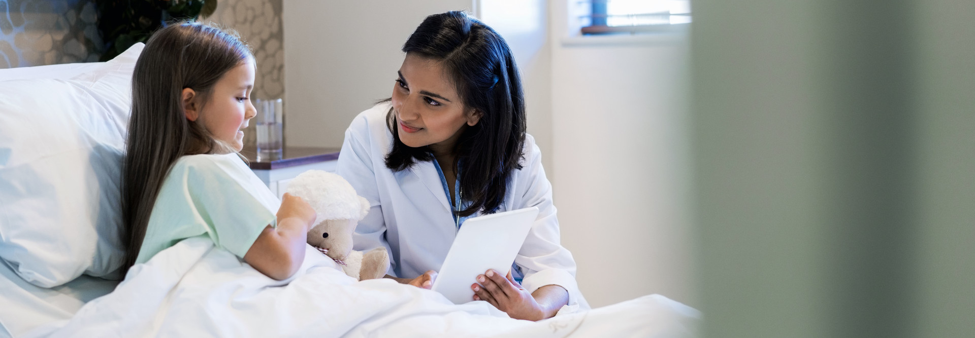 Doctor shares tablet with patient.