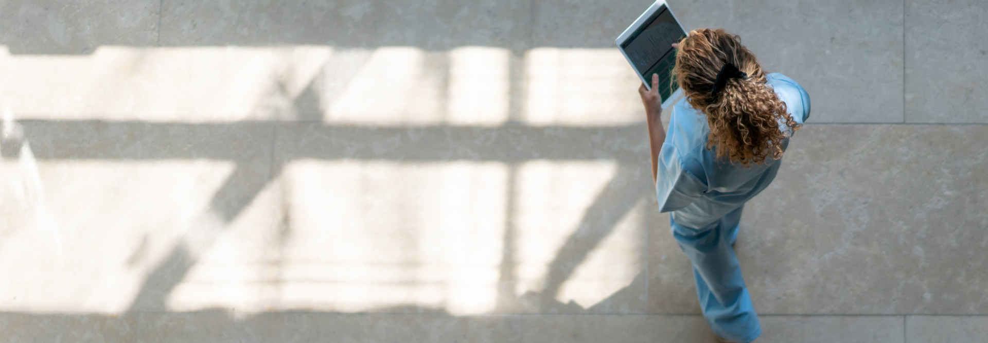 Nurse walking with tablet