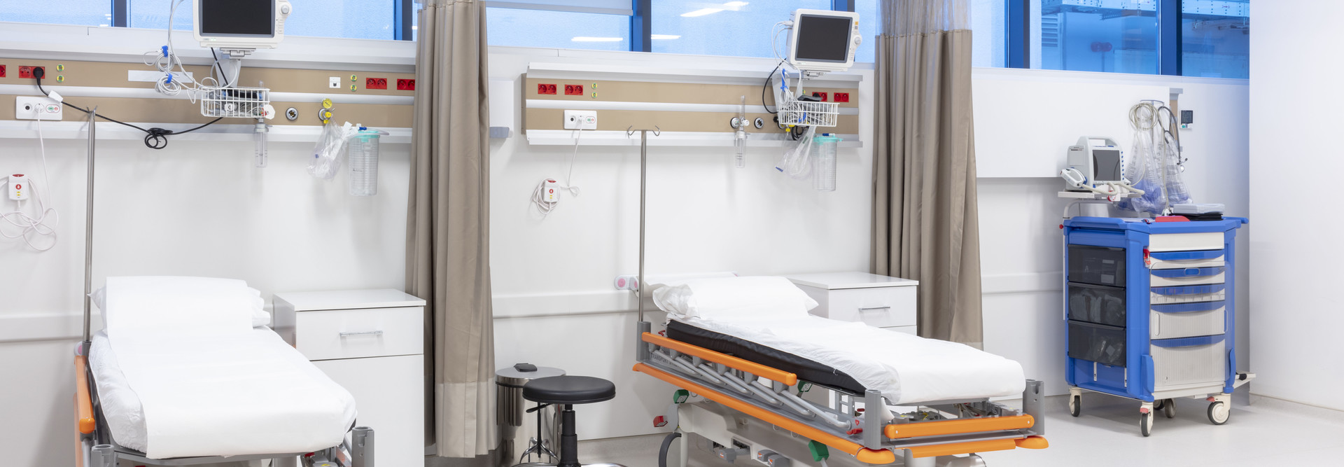 Empty hospital beds with tech