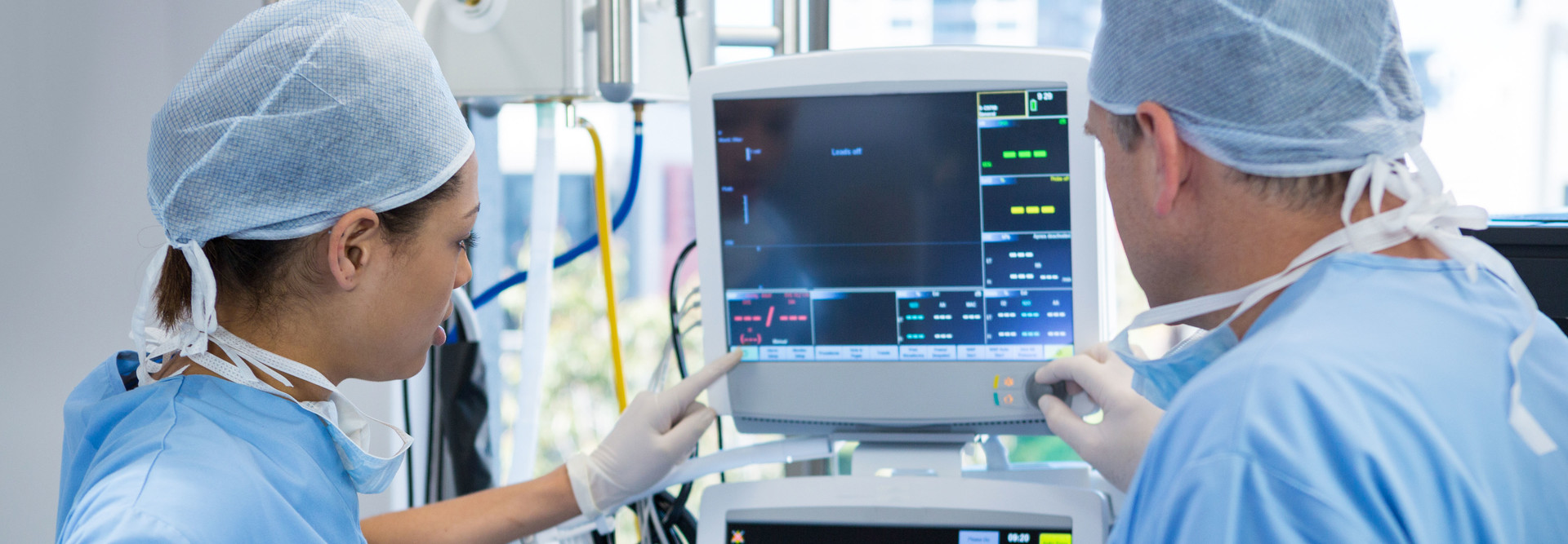 Surgeons look at device screen