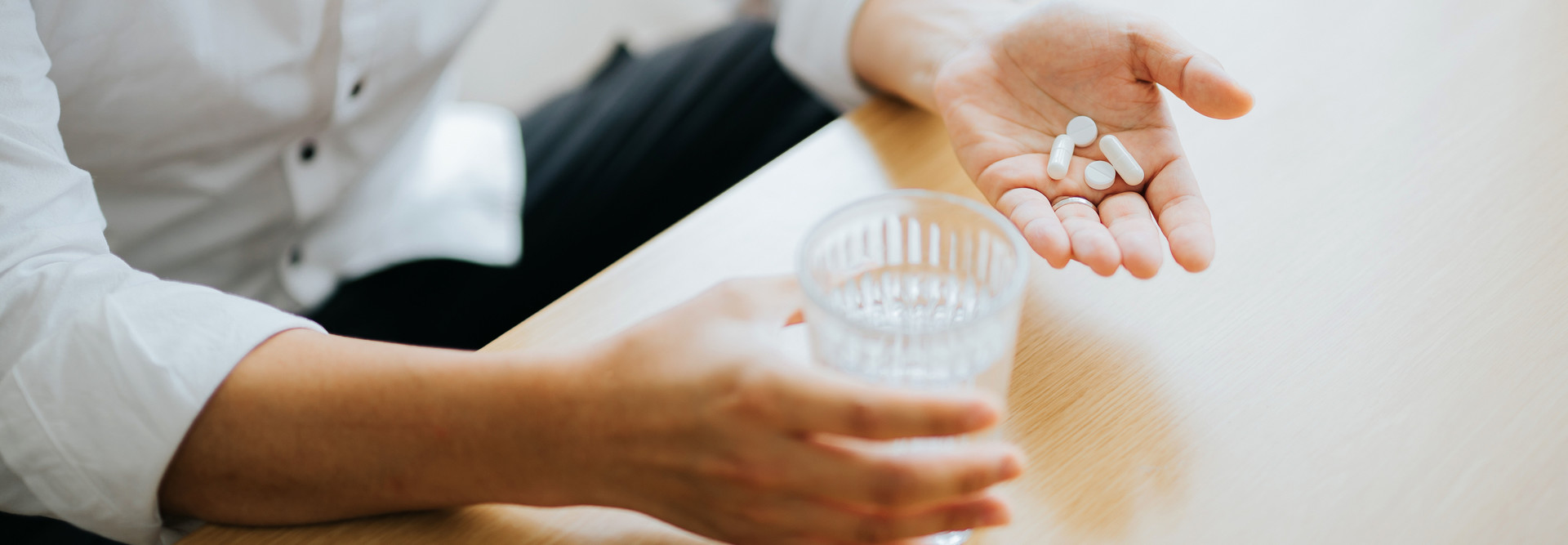 Man holds pill in hand