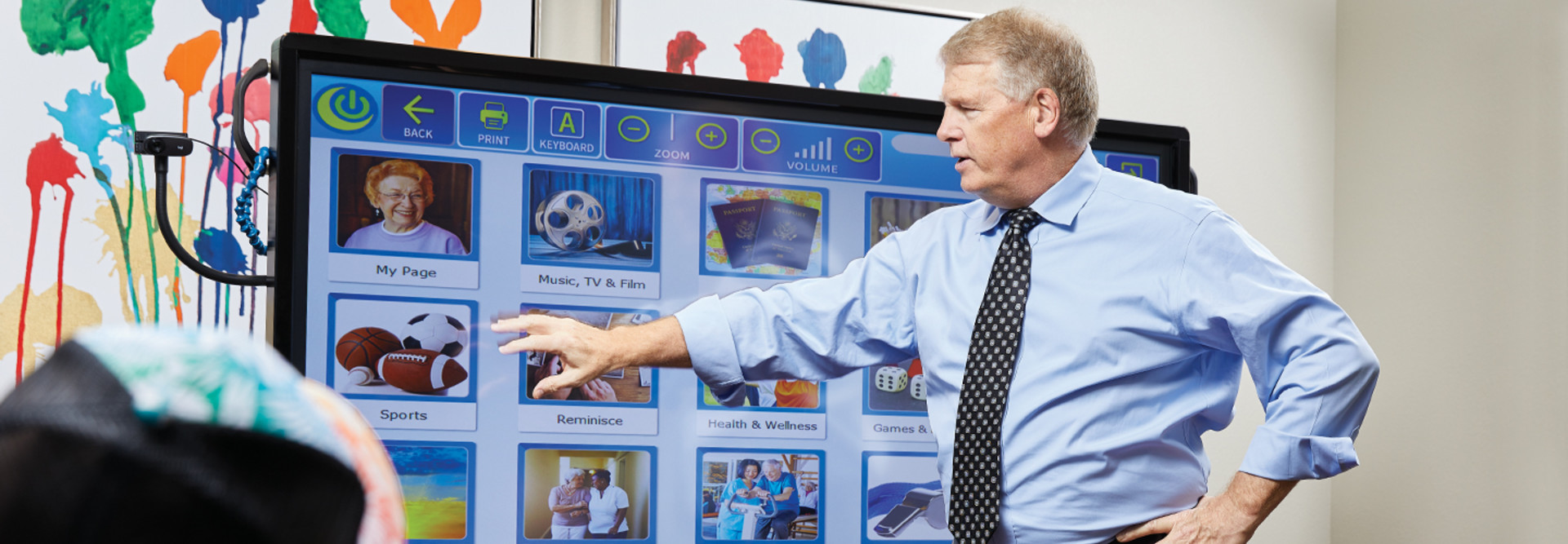 Chip Burns, CIO of Sun Health Communities, demonstrates interactive touch-screen technology that facilitates brain games, exercise routines and video chat, among other capabilities.