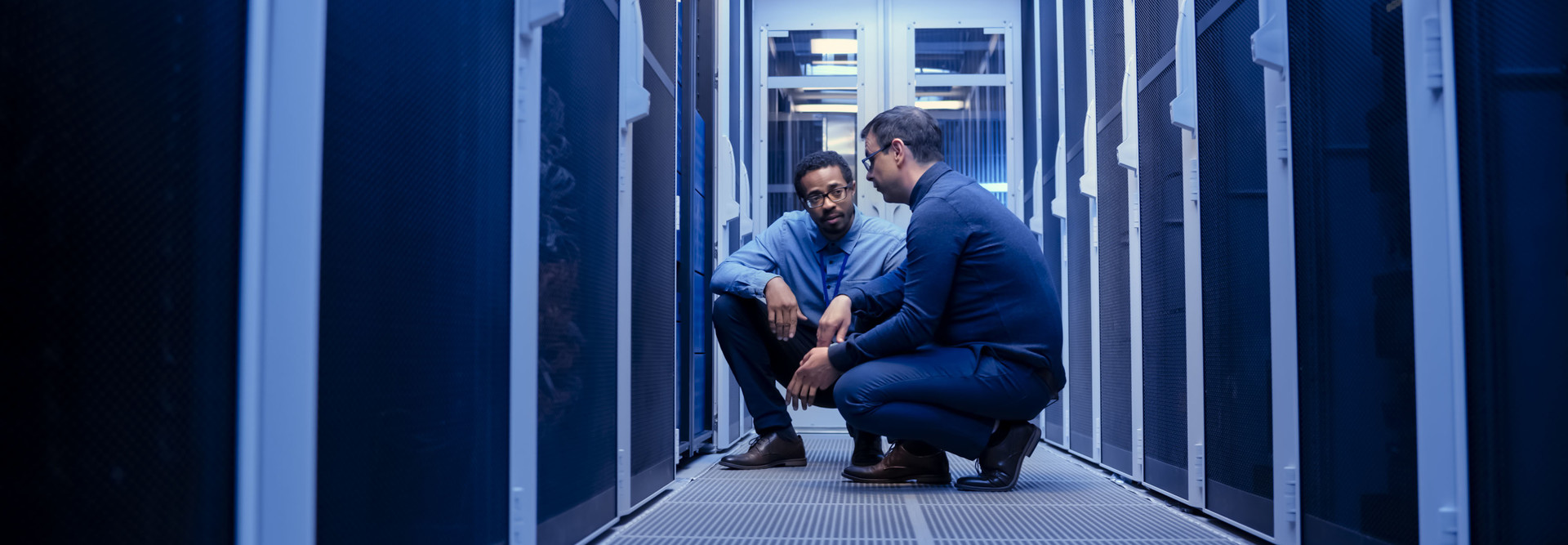 Two engineers in server room