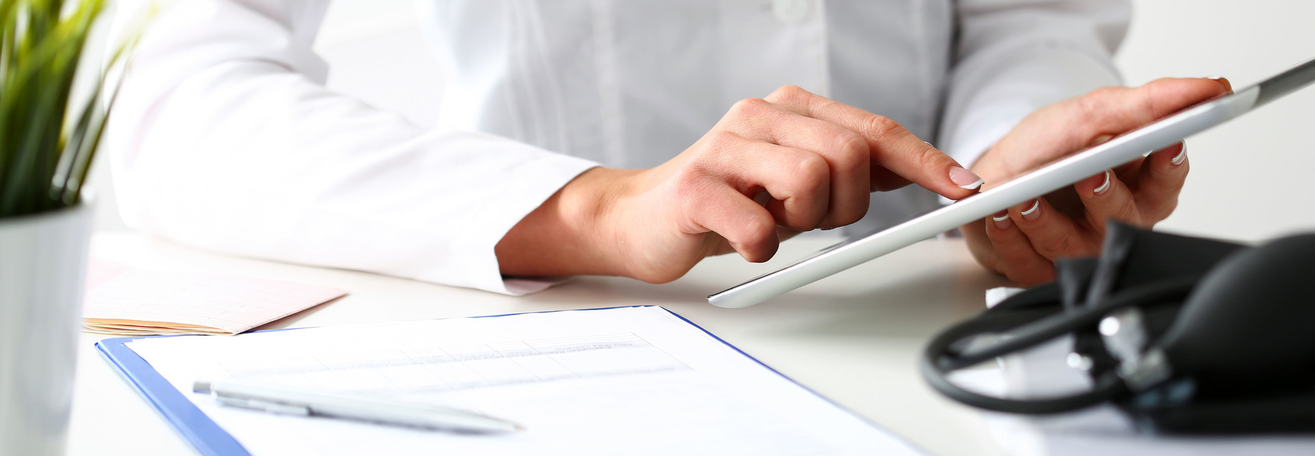 Doctor reads patient data on tablet