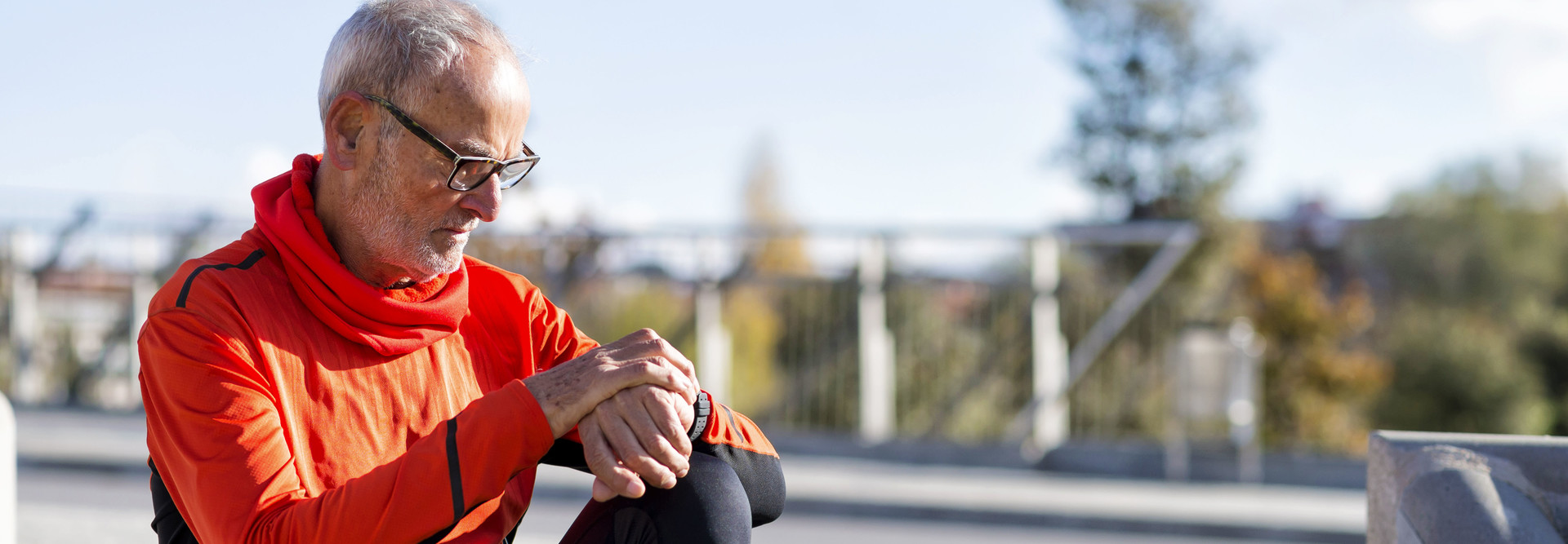 runner looks at smartwatch
