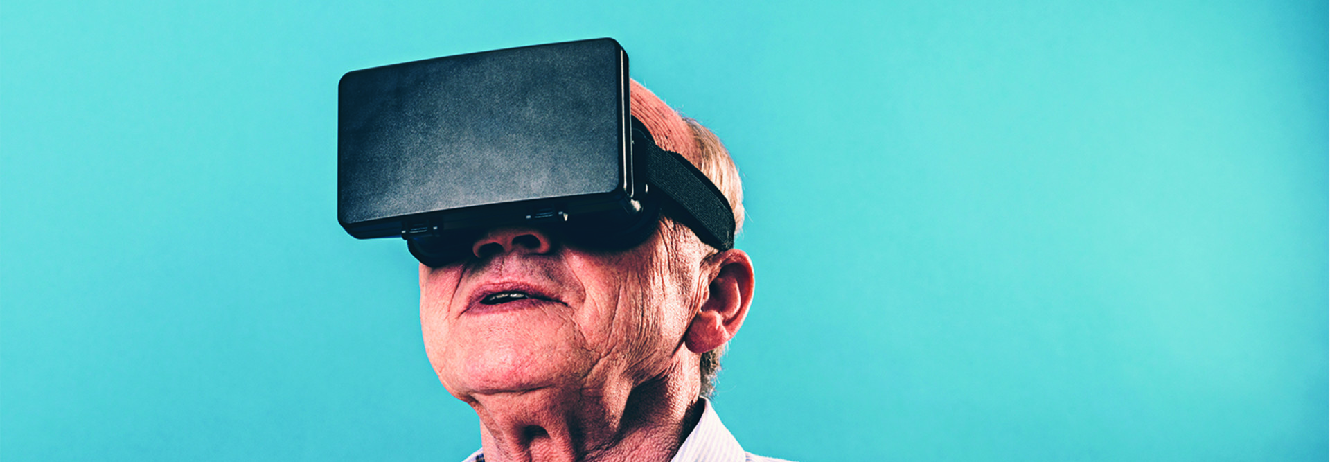 Senior man using VR headset