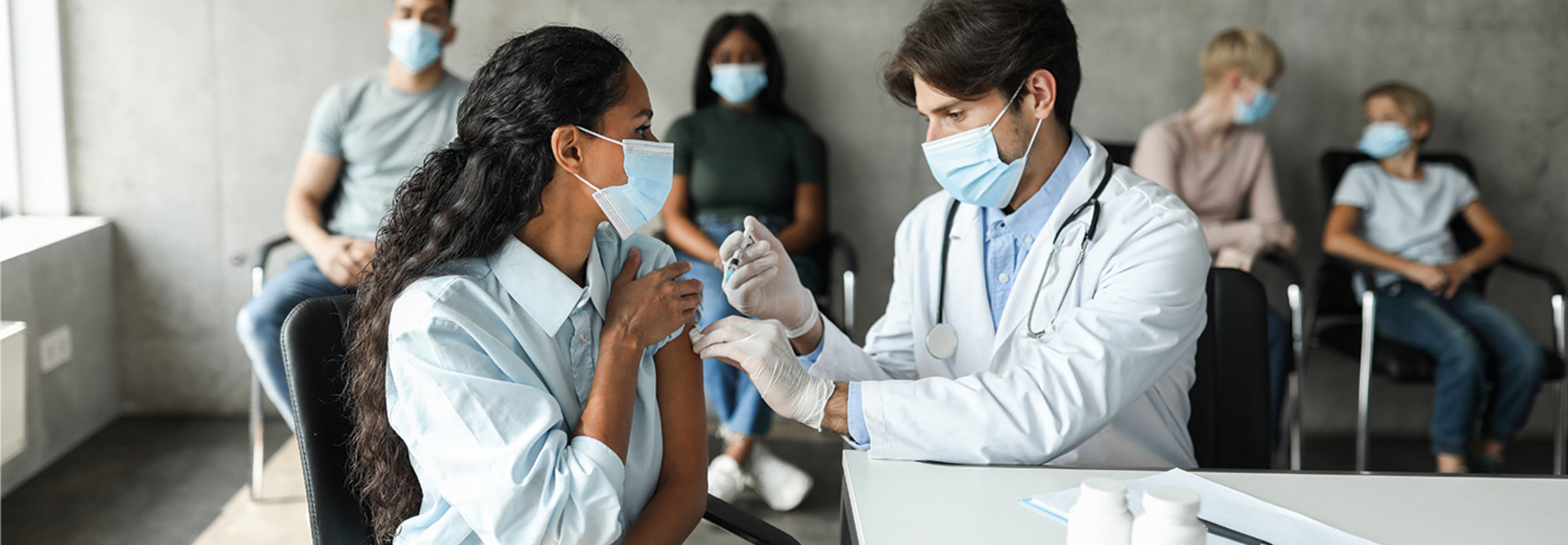 male doctor vaccinating female patient