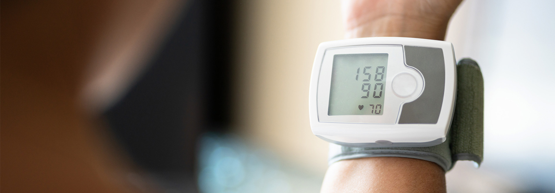 person uses blood pressure cuff