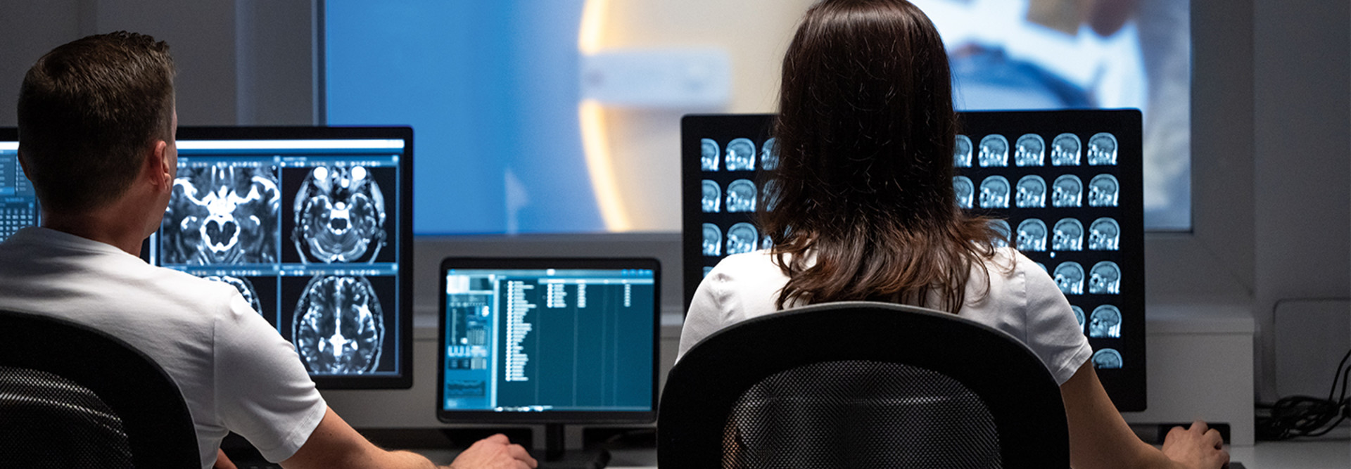 male and female clinicians review medical images