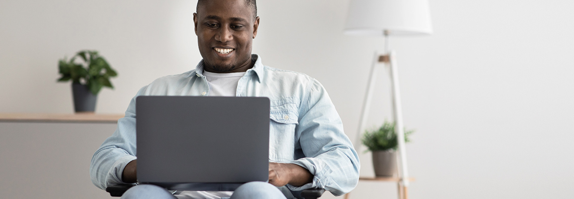 man attends telehealth visit on laptop