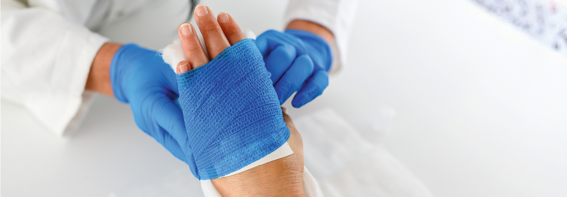 doctor dresses patient's wound on hand