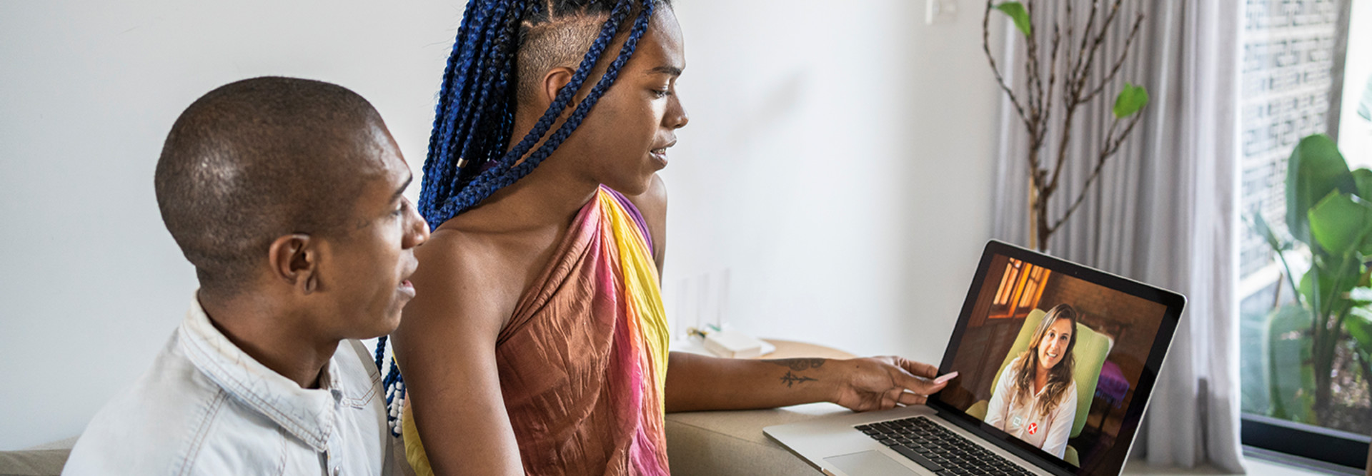 lgbtq couple attend telehealth appointment