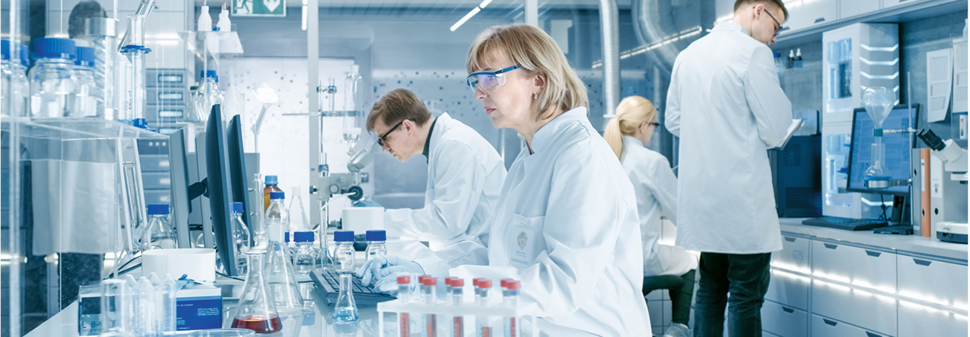 woman looks at patient data in modern lab