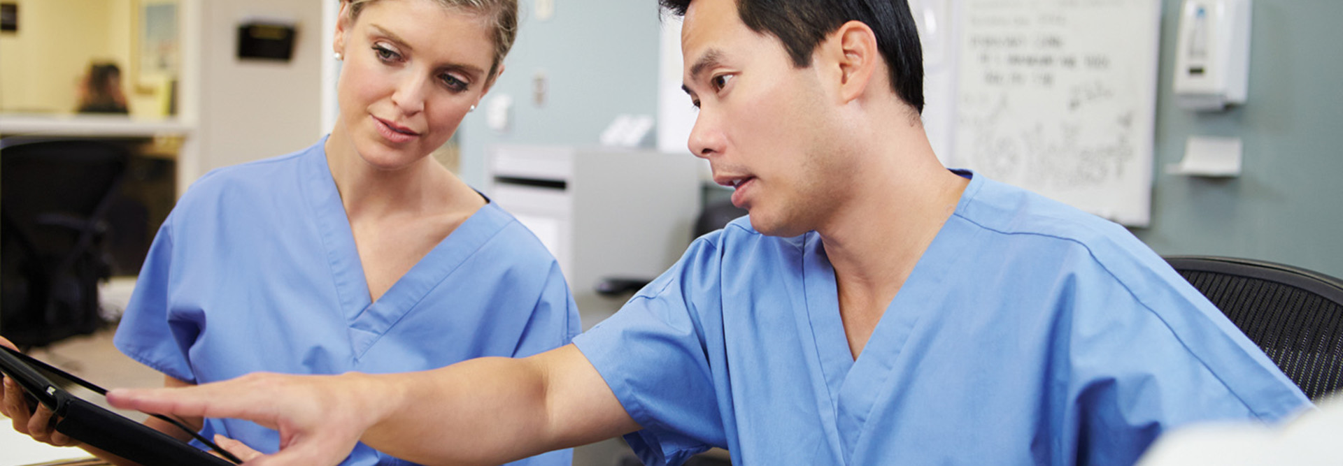 Two clinicians at a workstation 