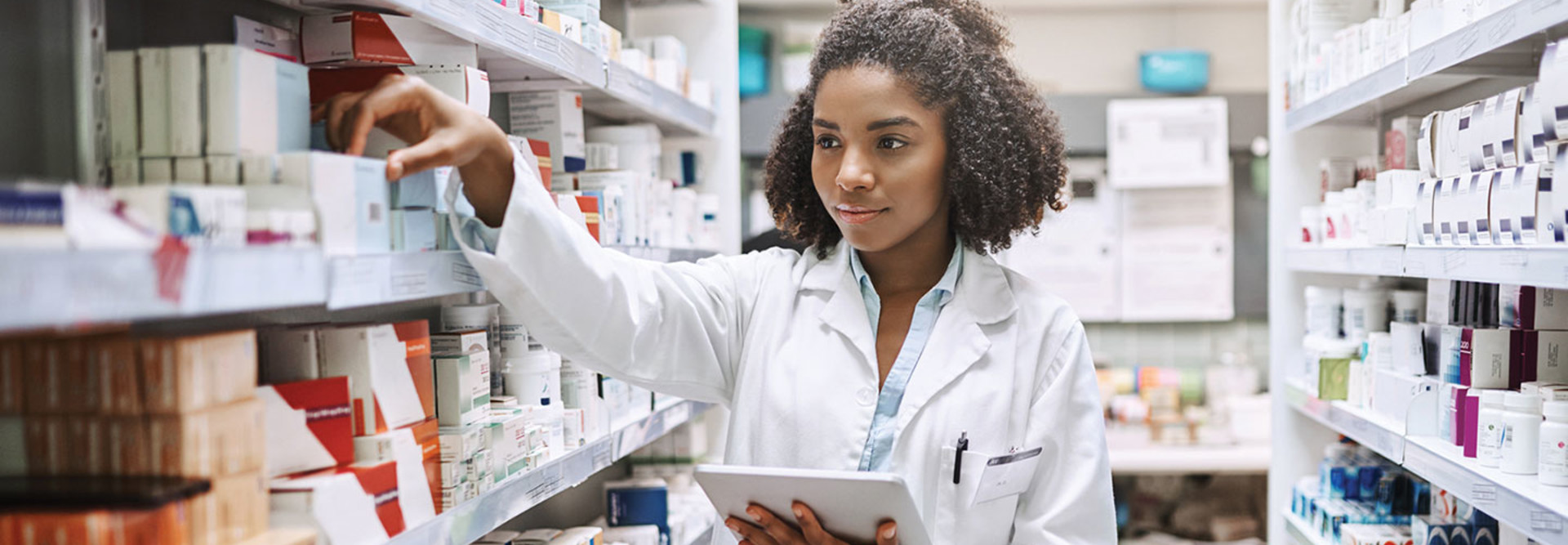 Pharmacy technician uses a tablet to fulfill a prescription order