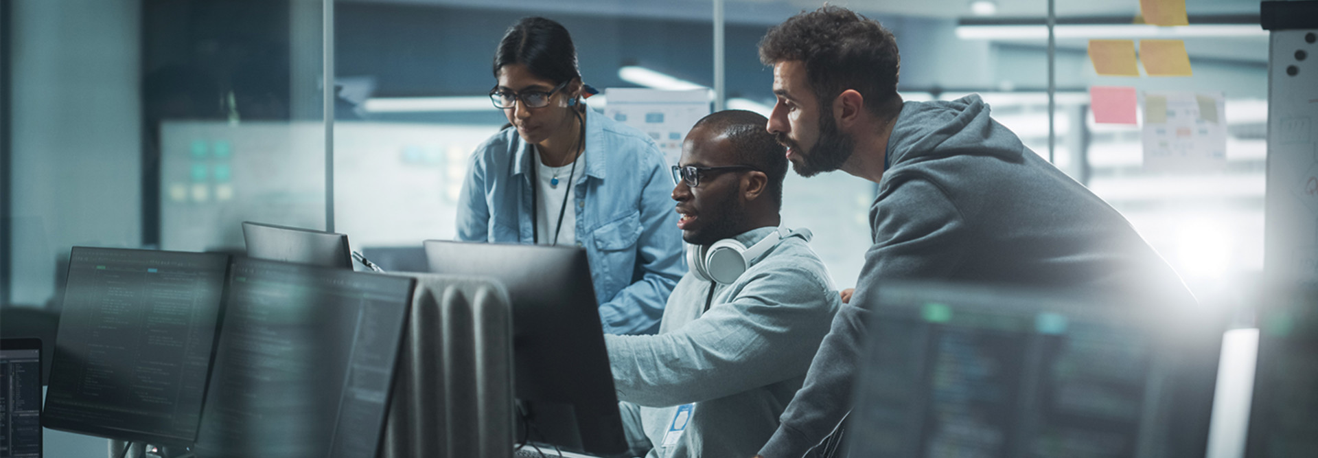 IT team look at computer monitor
