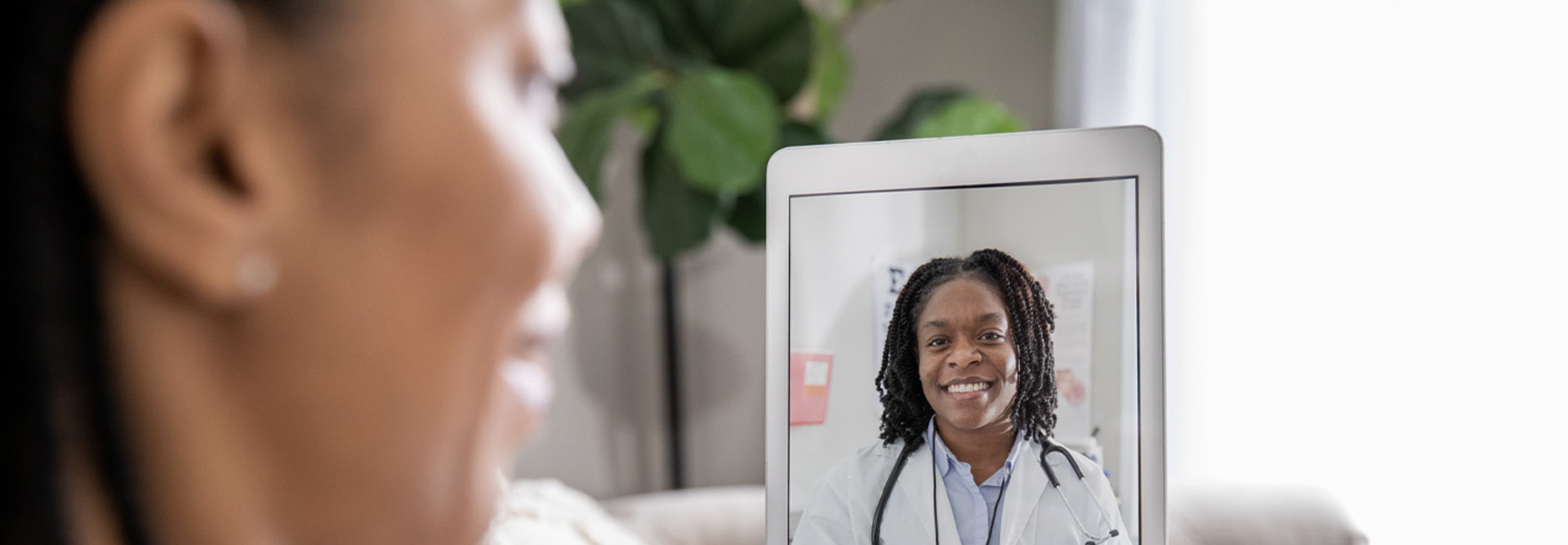 Person speaking to doctor via telehealth
