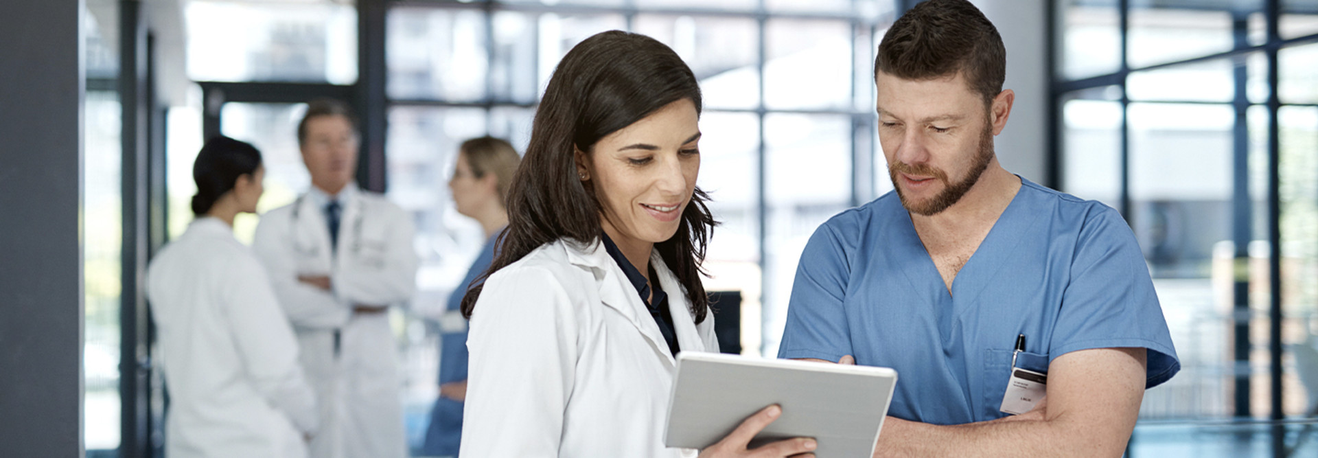 Two doctors using a digital tablet