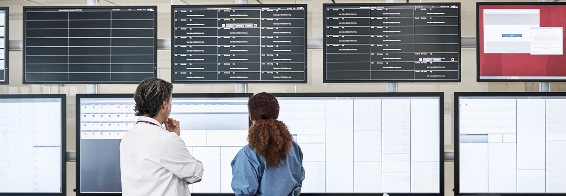 Doctors discussing over screens in control room