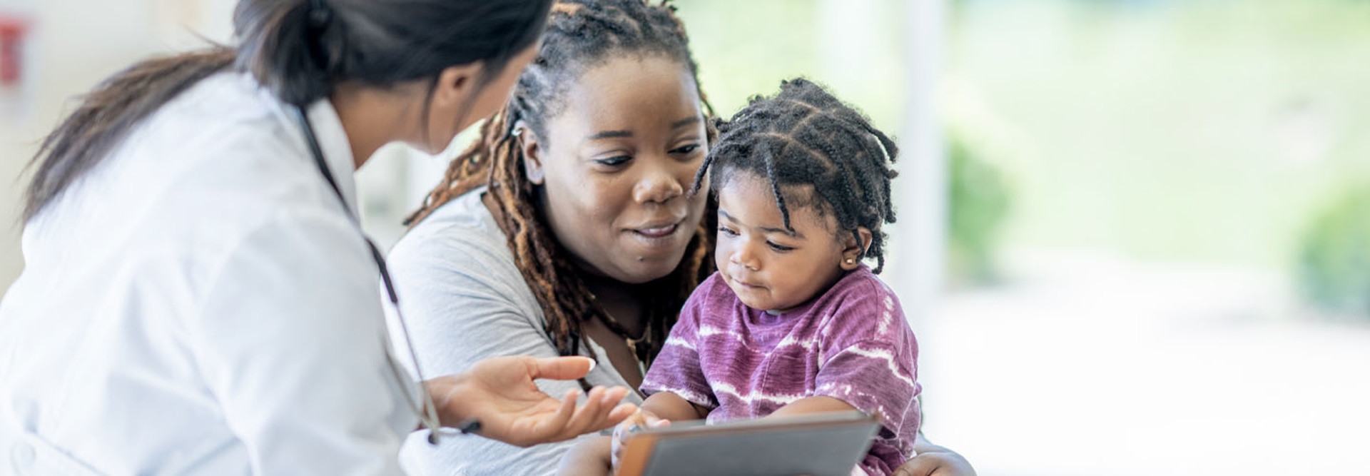 Parent and child speaking with doctor