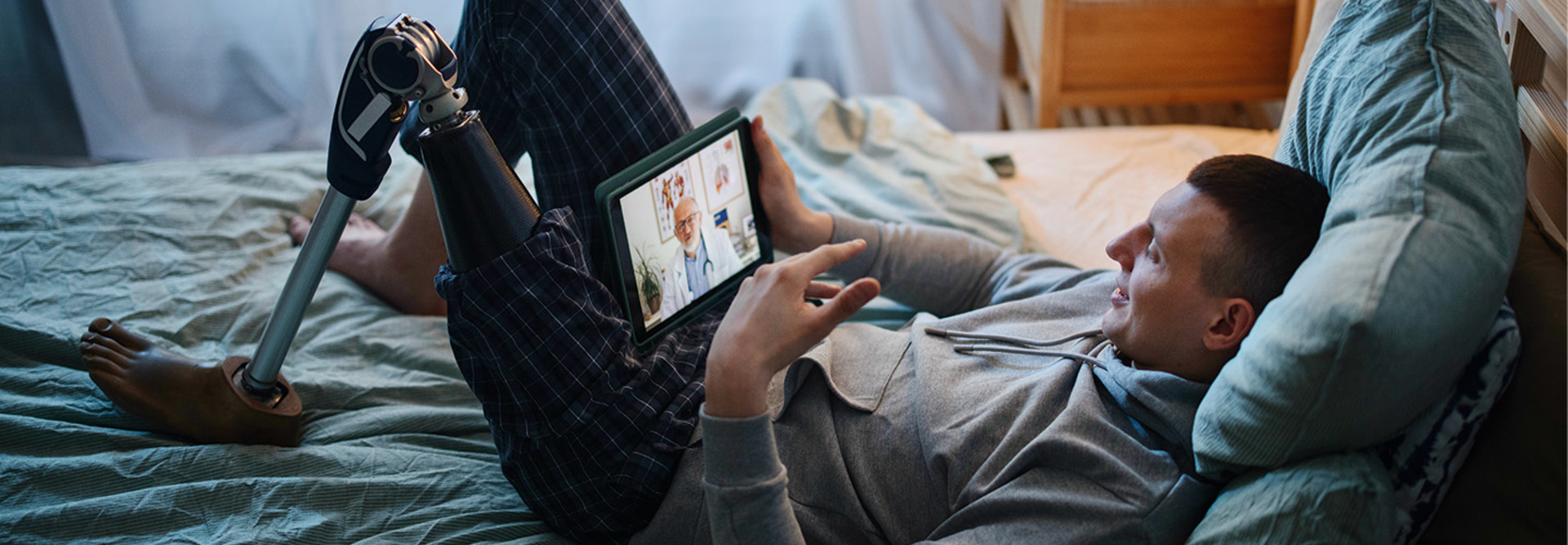 Man with prosthetic leg attends telehealth appointment at home