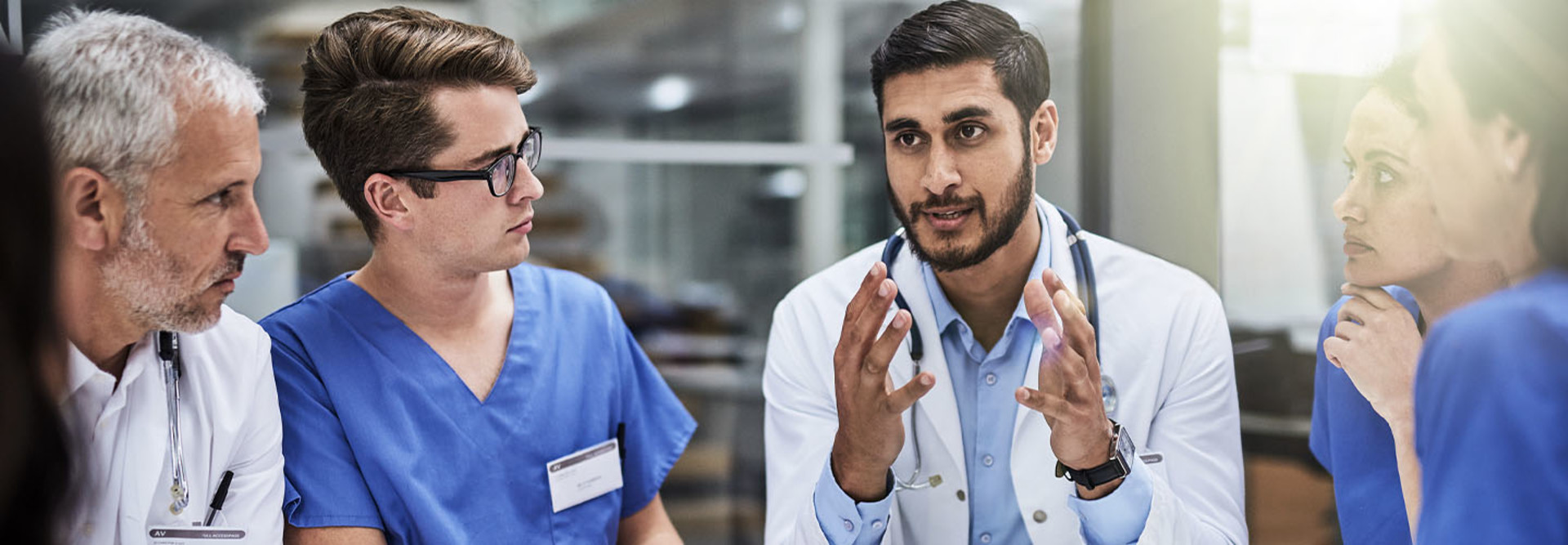 Group of doctors conversing in meeting