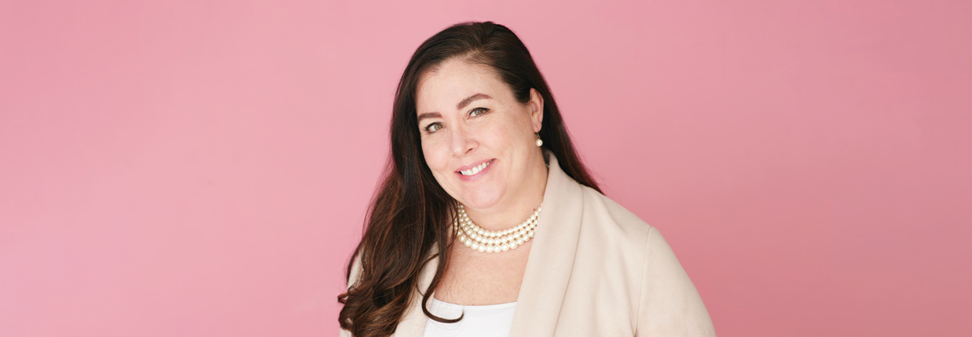 Dr. Sarah Pletcher against pink background