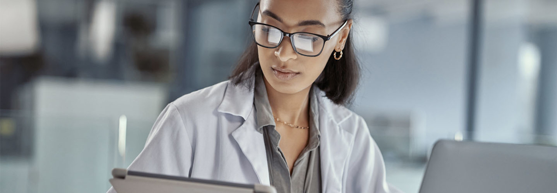 Doctor using tablet and laptop