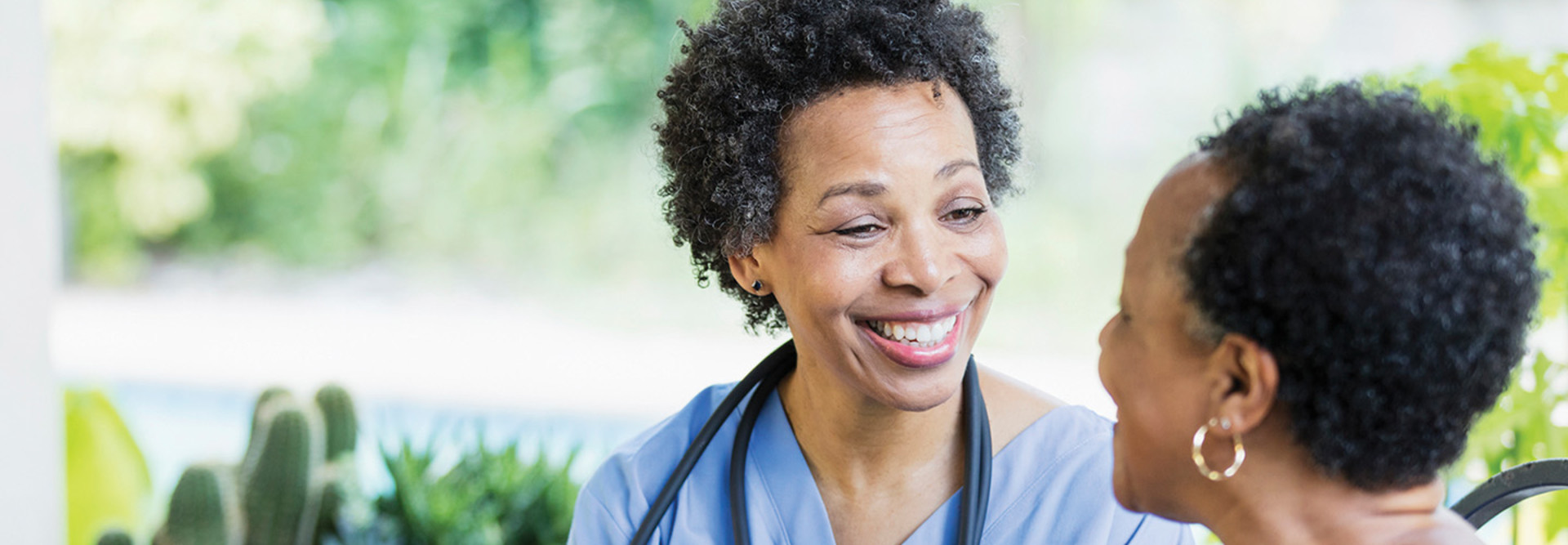 Nurse speaks to an older adult woman