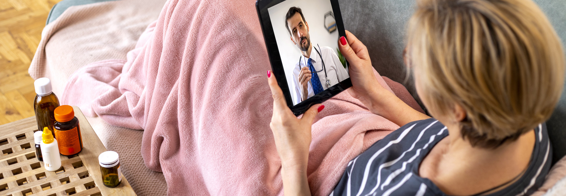 Mature woman using digital tablet for conversation with her doctor. 