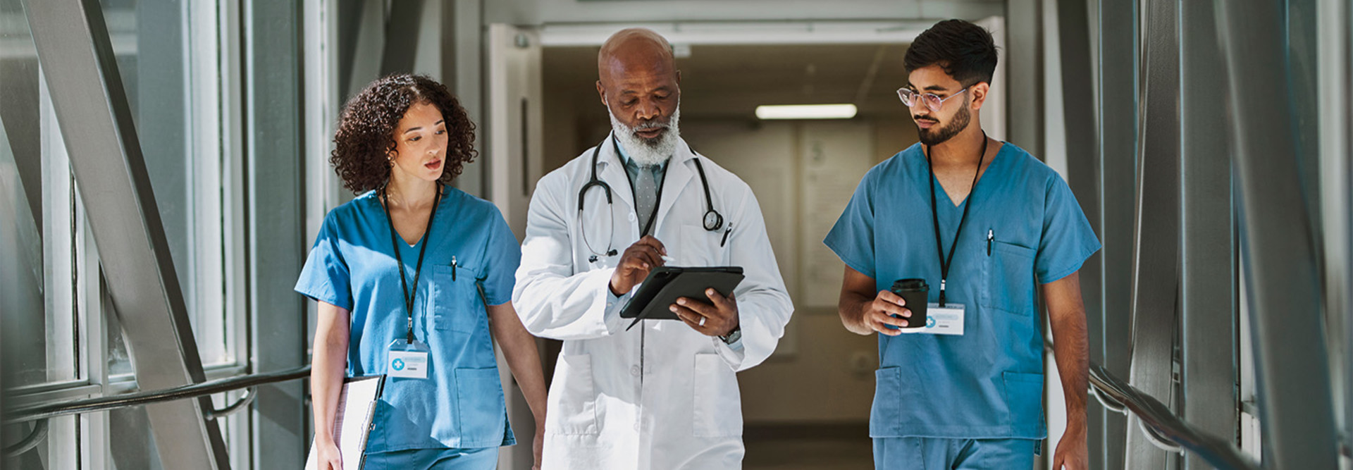 a doctor and two nurses walk together